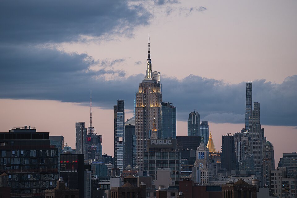 Two people climb the antenna of the Empire State Building with a banner in New York City."